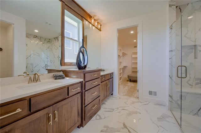 bathroom with a shower with door and vanity