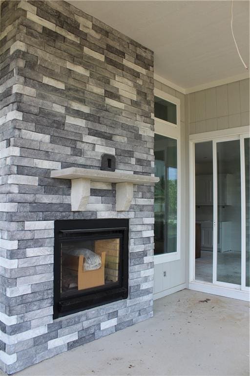 interior details featuring an outdoor fireplace and concrete flooring