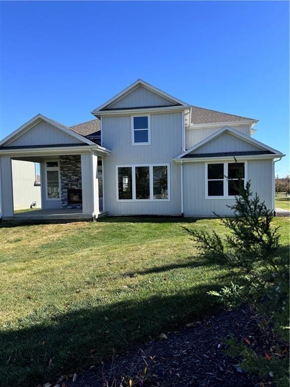 rear view of property with a yard