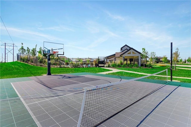 view of basketball court with a yard