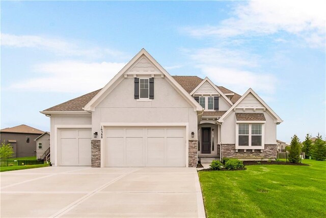 16388 S Brougham Dr, Olathe, KS 66062 - craftsman-style house with concrete driveway, stucco siding, a front yard, and stone siding