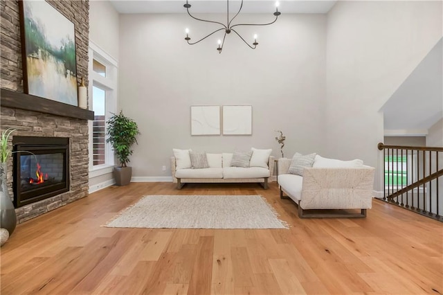 16388 S Brougham Dr, Olathe, KS 66062 - living room with wood finished floors, a high ceiling, a notable chandelier, and a fireplace