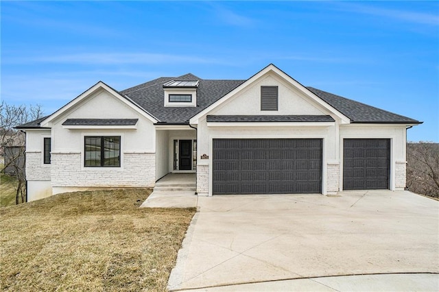 view of front facade with a front yard and a garage