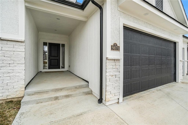 view of exterior entry with a garage