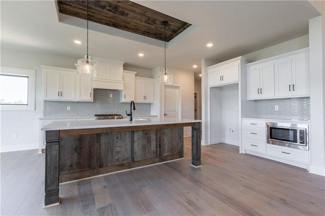 kitchen with dark hardwood / wood-style floors, backsplash, and hanging light fixtures