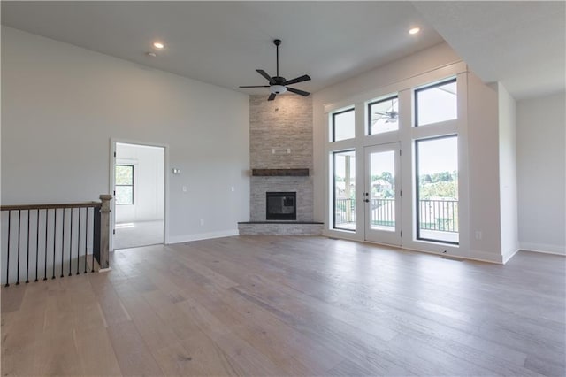 unfurnished living room with a fireplace, a healthy amount of sunlight, and light hardwood / wood-style floors