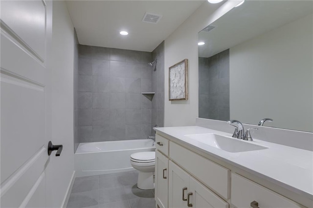 full bathroom featuring tiled shower / bath, toilet, tile floors, and oversized vanity