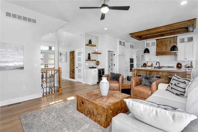 living room featuring french doors, sink, ceiling fan, beamed ceiling, and light hardwood / wood-style flooring