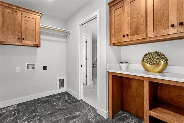 clothes washing area with electric dryer hookup, cabinets, dark tile floors, and hookup for a washing machine