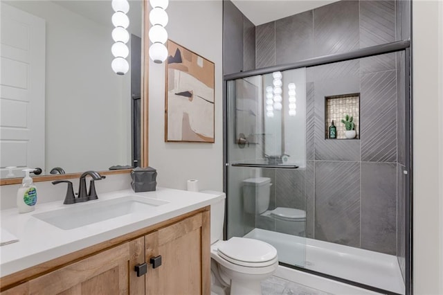 bathroom with oversized vanity, toilet, tile floors, and a shower with shower door