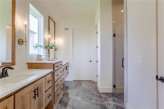 bathroom with walk in shower, vanity, and tile flooring