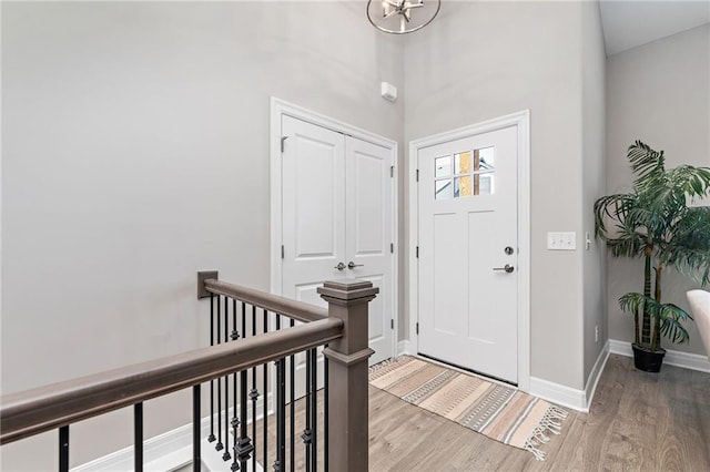 foyer featuring a towering ceiling and hardwood / wood-style flooring