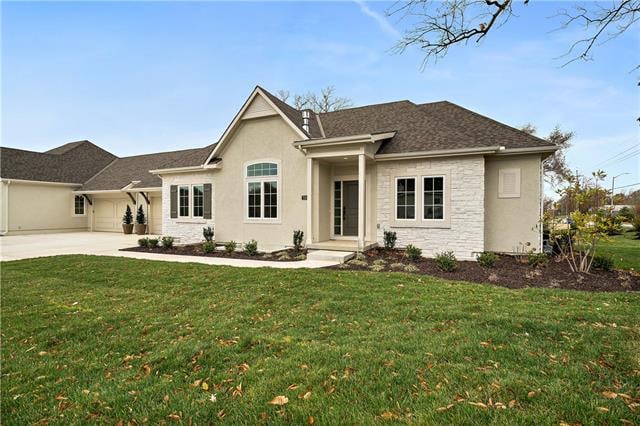 view of front of home with a front yard and a garage