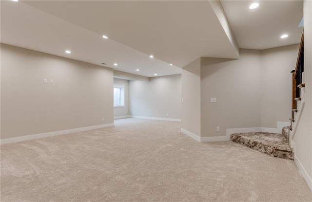 basement featuring light colored carpet