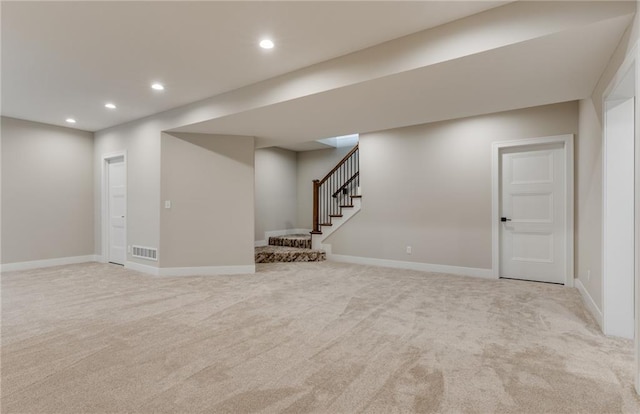 basement featuring light colored carpet