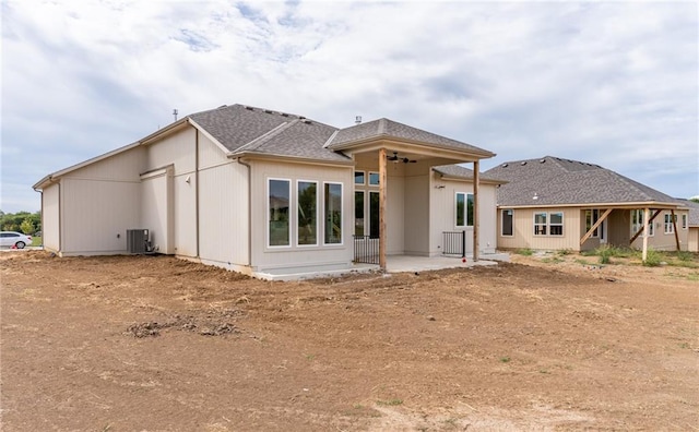 rear view of house with central AC unit and a patio