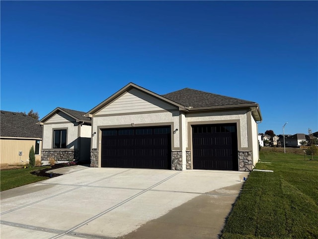 view of front of property with a front lawn and a garage