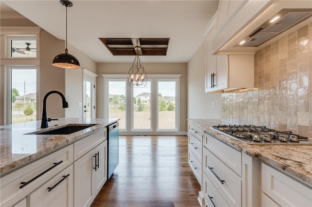 kitchen featuring dark hardwood / wood-style flooring, tasteful backsplash, white cabinetry, pendant lighting, and sink