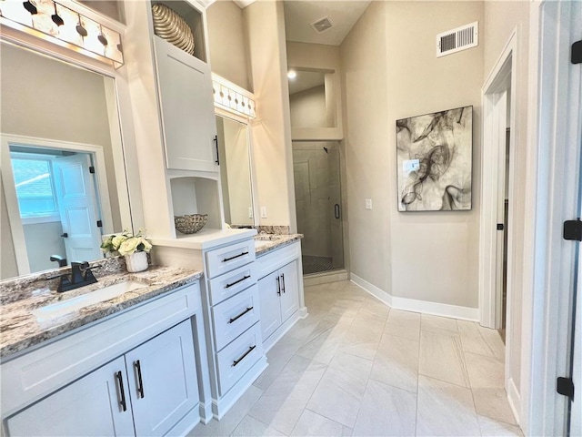 bathroom featuring tile flooring, vanity, and a tile shower