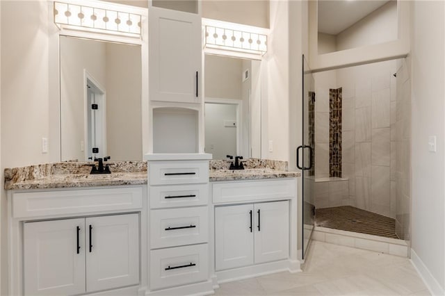 bathroom featuring dual vanity, walk in shower, and tile floors