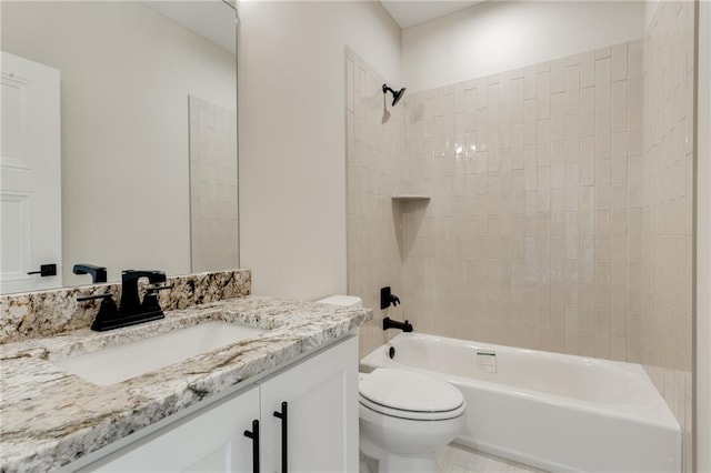 full bathroom with tile flooring, toilet, tiled shower / bath combo, and vanity