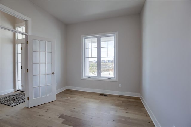 spare room featuring light wood-type flooring