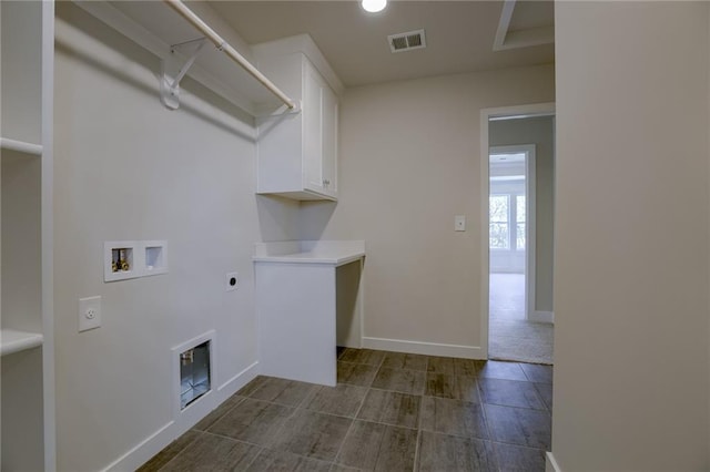 clothes washing area with hookup for a washing machine, cabinets, and hookup for an electric dryer