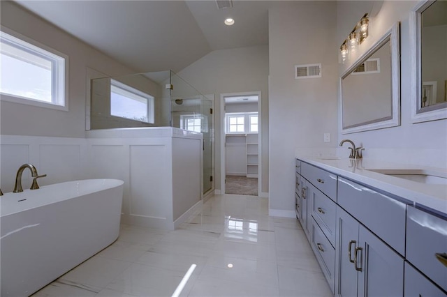 bathroom with vanity, lofted ceiling, and independent shower and bath