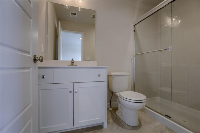 bathroom featuring tile patterned floors, vanity, toilet, and walk in shower