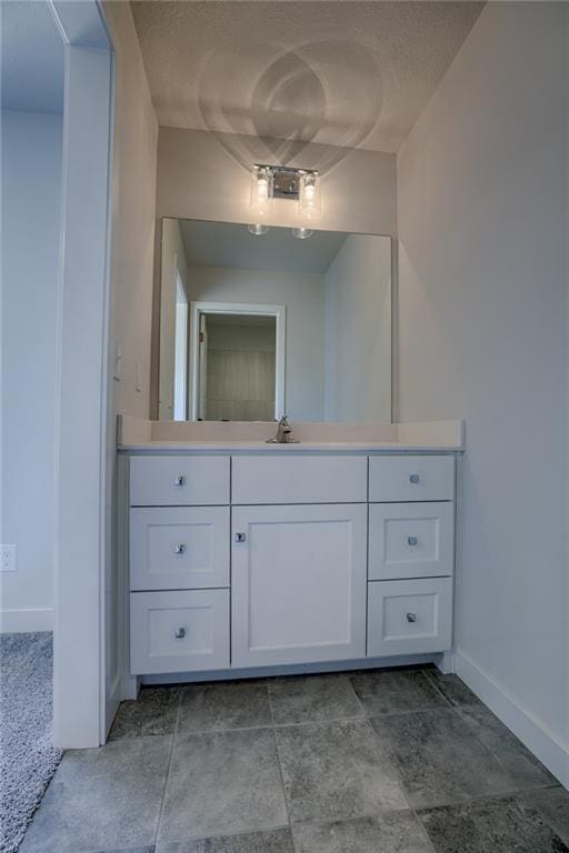 bathroom featuring vanity and a textured ceiling