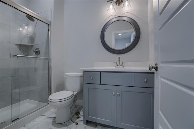 bathroom with an enclosed shower, vanity, and toilet