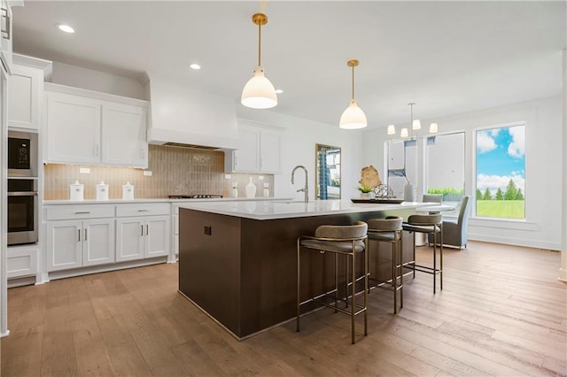 25212 W 92nd St, Lenexa, KS 66227 - kitchen featuring oven, white cabinetry, decorative backsplash, and light wood finished floors