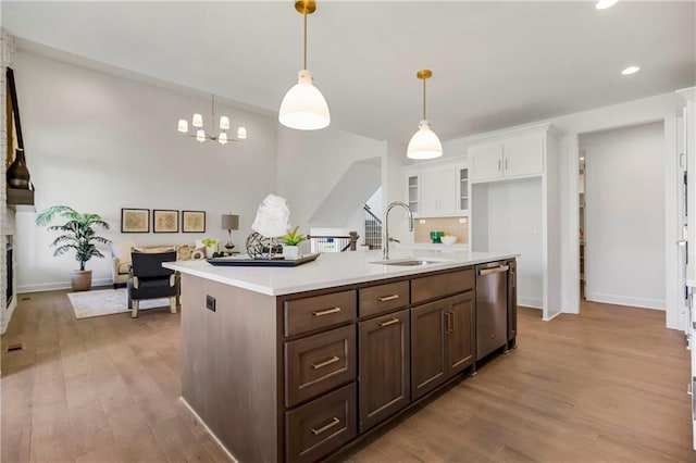 25212 W 92nd St, Lenexa, KS 66227 - kitchen with white cabinetry, stainless steel dishwasher, light wood-style flooring, a sink, and light countertops