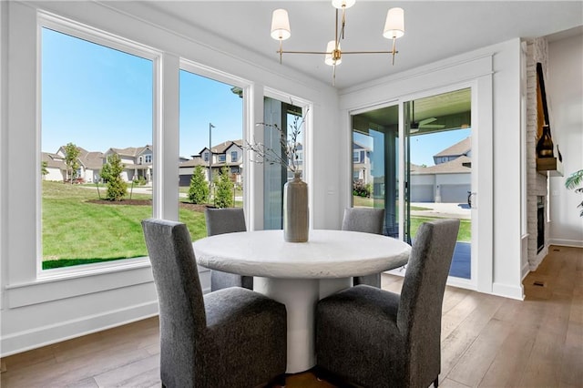 25212 W 92nd St, Lenexa, KS 66227 - dining space with a residential view, a notable chandelier, wood-type flooring, and baseboards