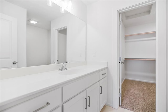 25212 W 92nd St, Lenexa, KS 66227 - bathroom with baseboards, a spacious closet, and vanity