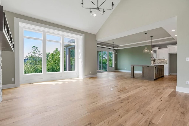 23217 W 124th Pl, Olathe, KS 66061 - unfurnished living room featuring a chandelier, light wood-type flooring, recessed lighting, and high vaulted ceiling