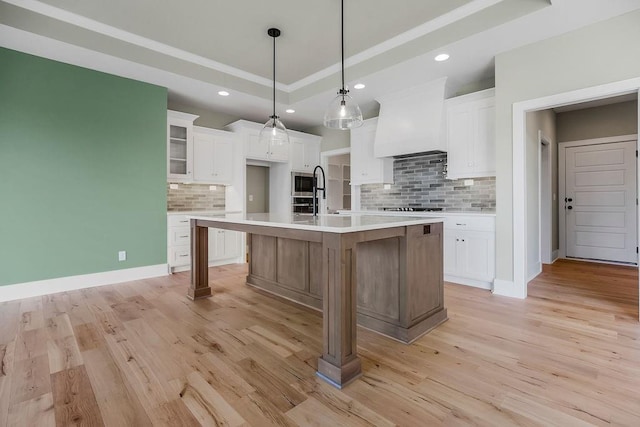 23217 W 124th Pl, Olathe, KS 66061 - kitchen featuring custom range hood, decorative backsplash, white cabinets, light countertops, and recessed lighting