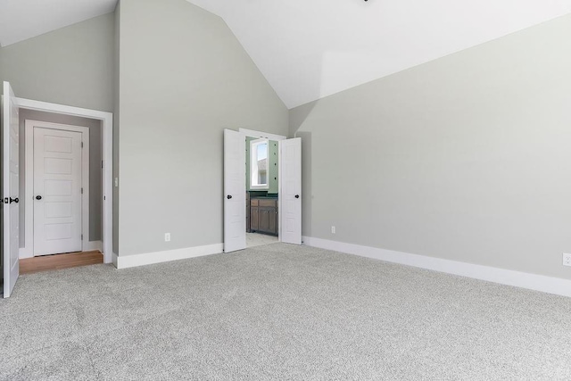 23217 W 124th Pl, Olathe, KS 66061 - unfurnished bedroom featuring light colored carpet, high vaulted ceiling, and connected bathroom