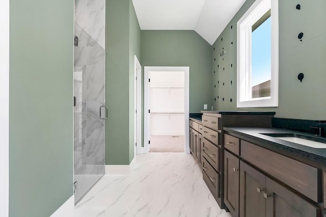 23217 W 124th Pl, Olathe, KS 66061 - bathroom featuring a shower stall, vanity, marble look tile flooring, lofted ceiling, and a spacious closet