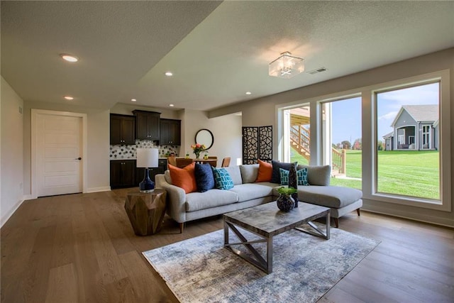23217 W 124th Pl, Olathe, KS 66061 - living room featuring wood finished floors, a textured ceiling, and recessed lighting