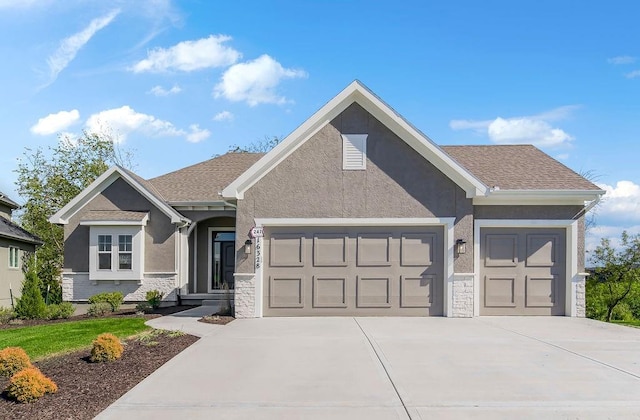 view of front of home featuring concrete driveway, a garage, stucco siding, and stone siding
