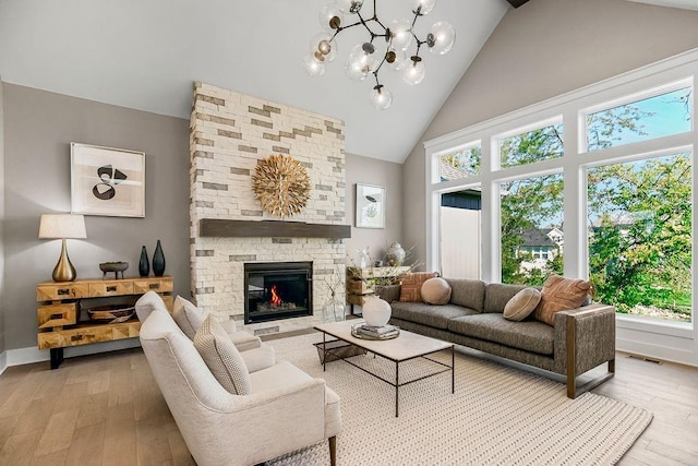 living room with wood-type flooring, high vaulted ceiling, visible vents, and plenty of natural light