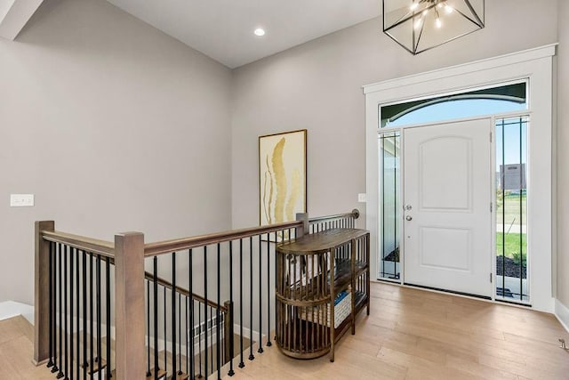 entryway featuring a wealth of natural light, a notable chandelier, recessed lighting, and wood finished floors