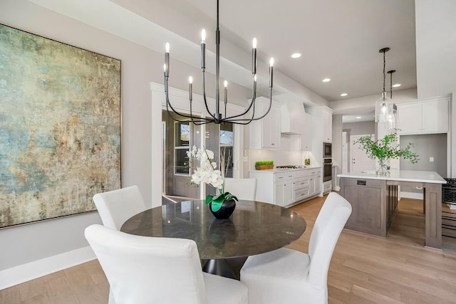 dining area featuring baseboards, a notable chandelier, light wood finished floors, and recessed lighting