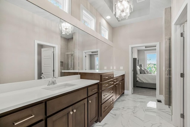 ensuite bathroom with an inviting chandelier, marble finish floor, a stall shower, and a high ceiling