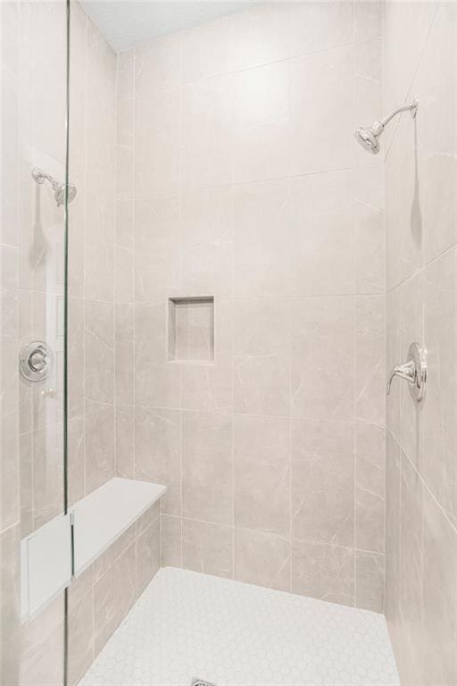 full bath with a tile shower