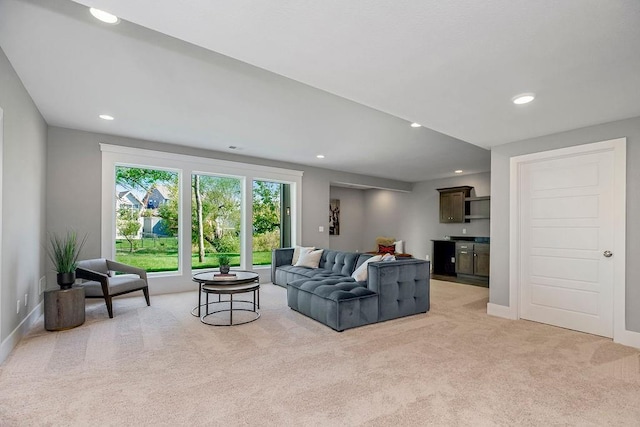 living room featuring baseboards, recessed lighting, and light colored carpet