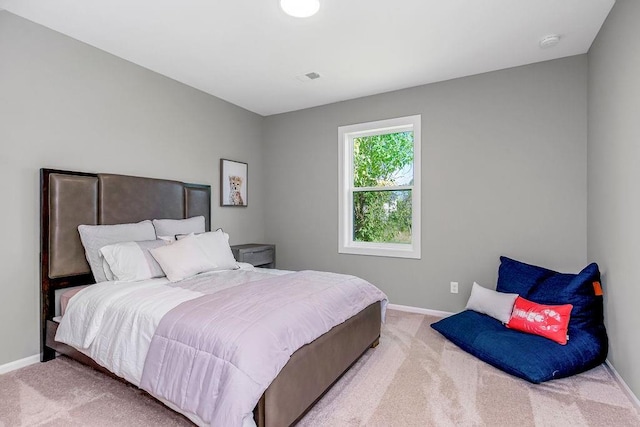 carpeted bedroom featuring baseboards and visible vents