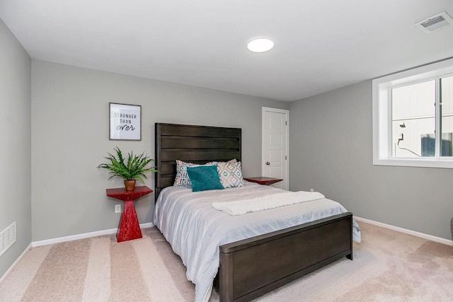 bedroom featuring baseboards, light carpet, and visible vents