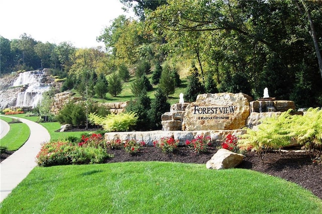 community / neighborhood sign with a lawn